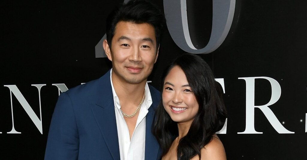 Simu Liu and Allison Hsu posing together on a red carpet